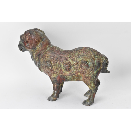 177 - A Chinese patinated bronzed Zodiac model of a ram, relief decorated with snakes, dragons and repeati... 