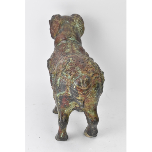 177 - A Chinese patinated bronzed Zodiac model of a ram, relief decorated with snakes, dragons and repeati... 