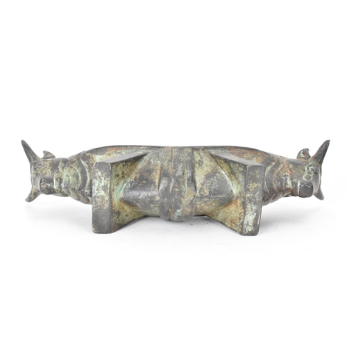 179 - A 20th century Chinese patinated bronzed oblong shaped bowl, the sides fashioned as two bulls heads ... 