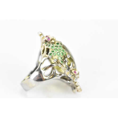 185 - A silver dress ring inset with a large lemon quartz to the centre, decorated with a dolphin and star... 