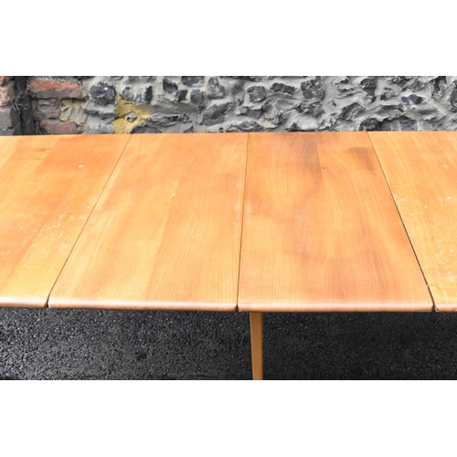 200 - A vintage Ercol elm and beech extending dining table with one folding leaf, on four splayed square t... 