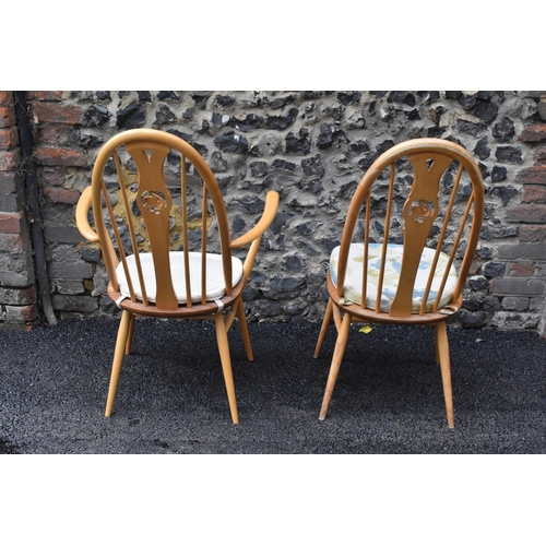 201 - An Ercol vintage gold label, elm seated and beech framed swan back carver chair and matching dining ... 