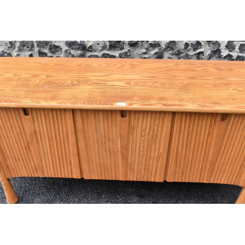 202 - A rare 20th century Ercol Saville elm sideboard The oversized plank top raised over a ridged base fi... 