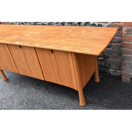 202 - A rare 20th century Ercol Saville elm sideboard The oversized plank top raised over a ridged base fi... 