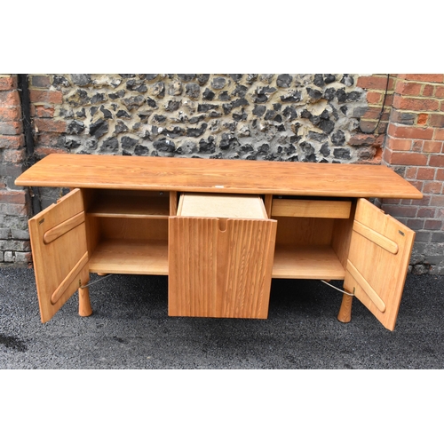 202 - A rare 20th century Ercol Saville elm sideboard The oversized plank top raised over a ridged base fi... 