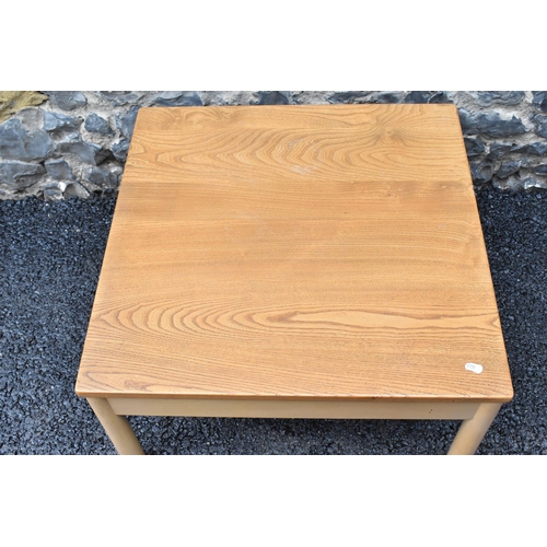 205 - A vintage Ercol Windsor range light elm and beech square topped coffee table, raised on four cylindr... 