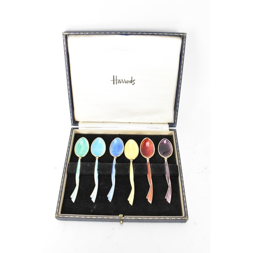 213 - A cased set of six mid 20th century coffee bean spoons, retailed by Harrods, all having guilloche en... 