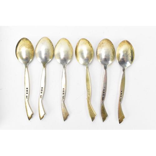 213 - A cased set of six mid 20th century coffee bean spoons, retailed by Harrods, all having guilloche en... 