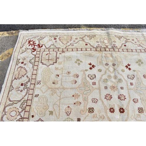 226 - A hand woven English design Zieglar Mahal rug, on a beige ground with repeating floral motifs, multi... 