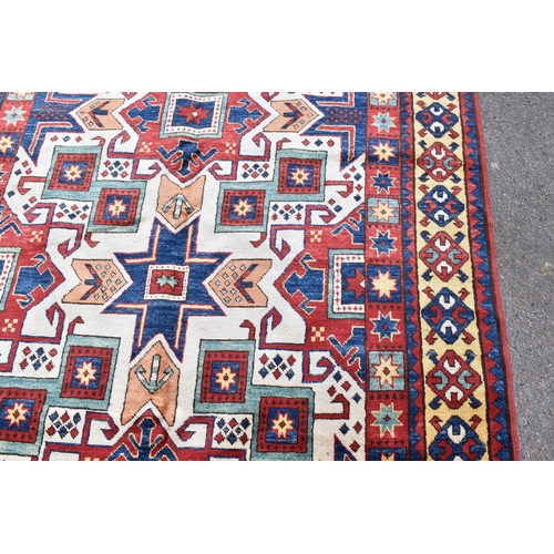 228 - A handwoven Caucasian star kazak rug, having a geometric designs with repeating motifs, multiguard b... 