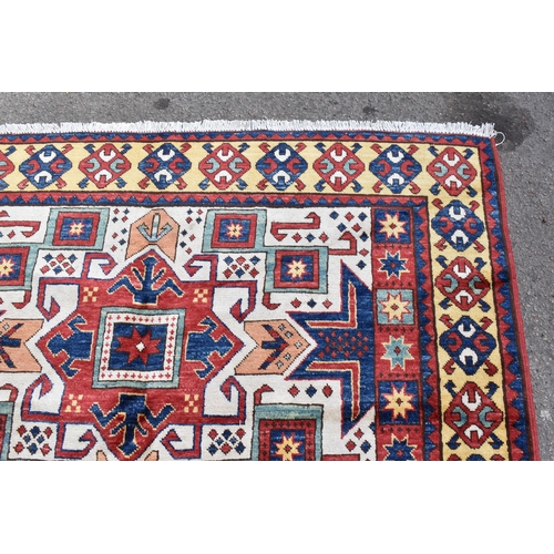 228 - A handwoven Caucasian star kazak rug, having a geometric designs with repeating motifs, multiguard b... 