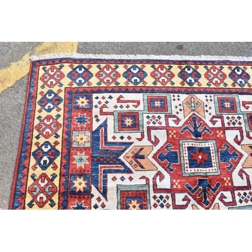 228 - A handwoven Caucasian star kazak rug, having a geometric designs with repeating motifs, multiguard b... 