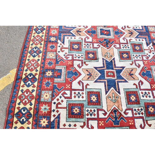 228 - A handwoven Caucasian star kazak rug, having a geometric designs with repeating motifs, multiguard b... 