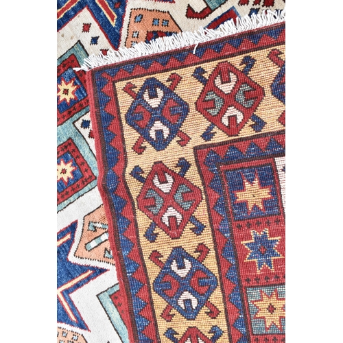 228 - A handwoven Caucasian star kazak rug, having a geometric designs with repeating motifs, multiguard b... 