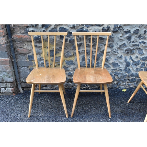 231 - A set of four Ercol blonde elm and beech kitchen dining chairs, model 391, having spindle stick back... 