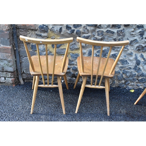 231 - A set of four Ercol blonde elm and beech kitchen dining chairs, model 391, having spindle stick back... 