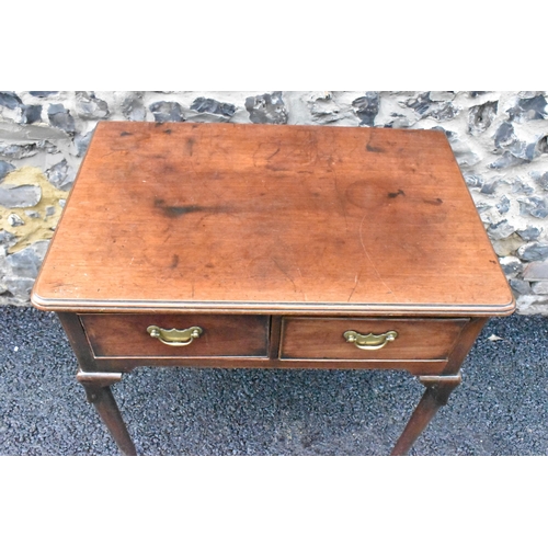 232 - A George II mahogany lowboy, having a rectangular top with rounded corners, two drawers with brass d... 