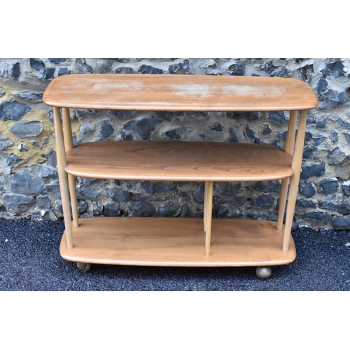 233 - A mid 20th century Ercol elm and beech Baby Giraffe three tier trolley, model 361, Windsor range, in... 