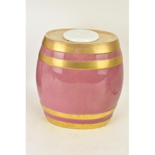 236 - A Victorian ceramic cloves barrel, of oval shape and decorated with a pink ground with gilt bands an... 