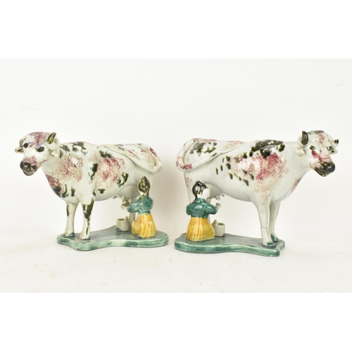 248 - Two early 19th century pearlware pink and green sponge decorated cow creamers with milkmaids, possib... 