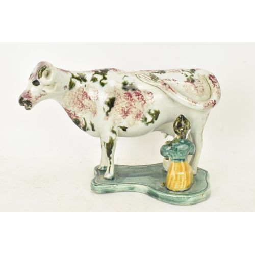 248 - Two early 19th century pearlware pink and green sponge decorated cow creamers with milkmaids, possib... 