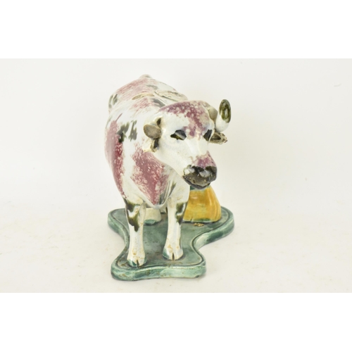 248 - Two early 19th century pearlware pink and green sponge decorated cow creamers with milkmaids, possib... 