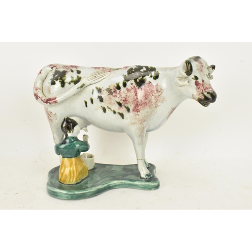 248 - Two early 19th century pearlware pink and green sponge decorated cow creamers with milkmaids, possib... 