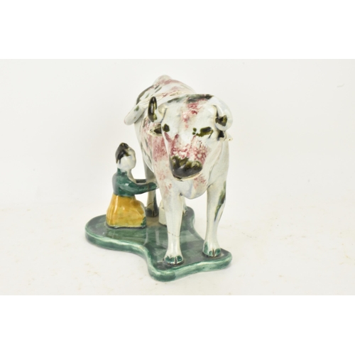 248 - Two early 19th century pearlware pink and green sponge decorated cow creamers with milkmaids, possib... 