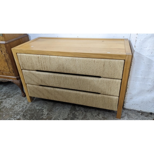 416 - A modern light oak chest of three drawers, the drawer fronts with woven decoration, 75.5h x 120w Loc... 