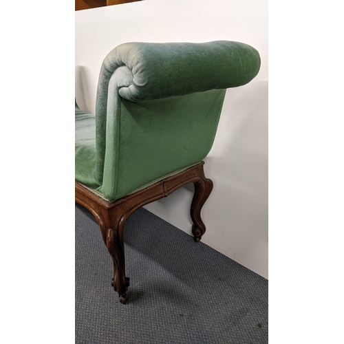 190 - A 19th century French walnut window seat having padded scroll ends, cabriole legs with carved scroll... 