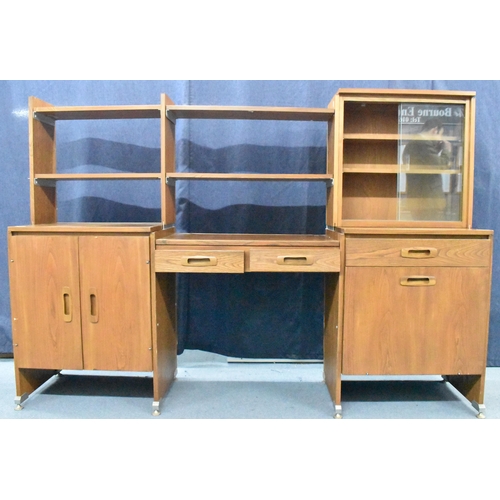 457 - A 1960s light elm desk, having a glazed section with two sliding doors and open shelves, above drawe... 