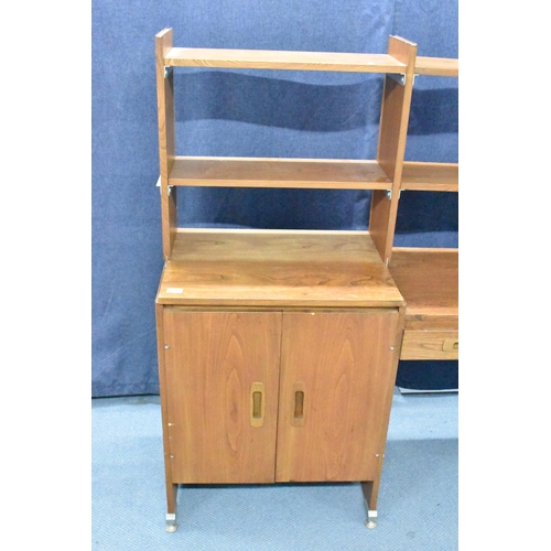 457 - A 1960s light elm desk, having a glazed section with two sliding doors and open shelves, above drawe... 