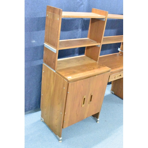 457 - A 1960s light elm desk, having a glazed section with two sliding doors and open shelves, above drawe... 