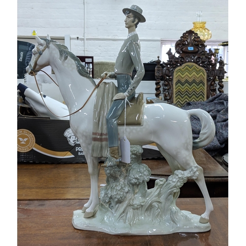 428 - A Lladro figure of an elegant man in smart dress on horseback, Location:8.5