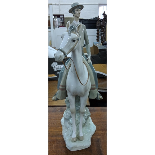 428 - A Lladro figure of an elegant man in smart dress on horseback, Location:8.5