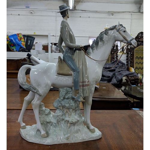 428 - A Lladro figure of an elegant man in smart dress on horseback, Location:8.5