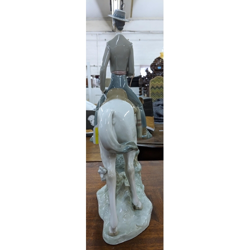 428 - A Lladro figure of an elegant man in smart dress on horseback, Location:8.5