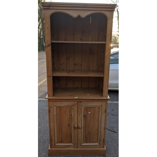 446 - A reconstituted pine bookcase cabinet with two shelves, over a pair of doors, 185cm h x 82cm w, Loca... 