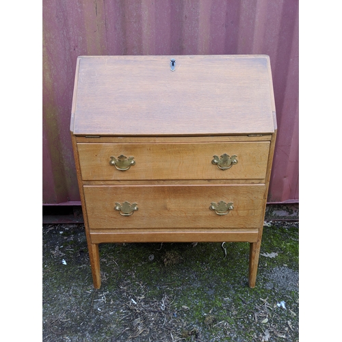 445 - A modern light oak bureau with a fall flap over two drawers, raised on straight legs, 101h x 76w, a ... 