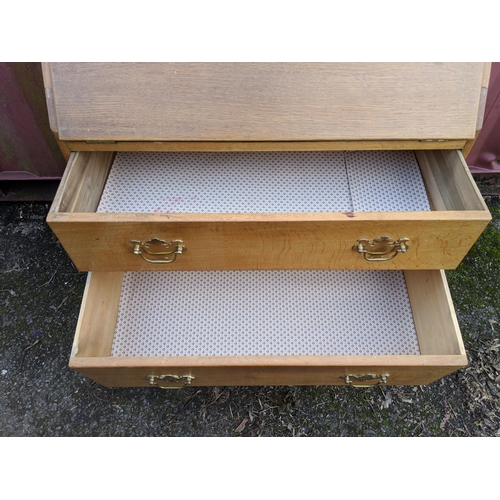 445 - A modern light oak bureau with a fall flap over two drawers, raised on straight legs, 101h x 76w, a ... 