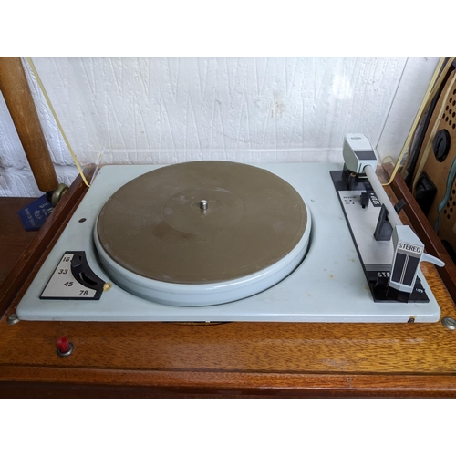 471 - A mid-century teak cased stereo record deck, and a Rigonda Marksman stereo audio radio with speaker ... 