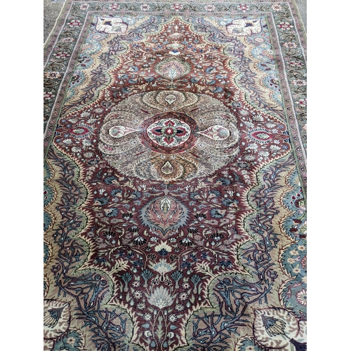 463 - A Turkish hand woven woollen carpet, central floral medallion surrounded by all over floral designs,... 