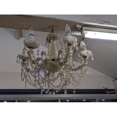 449 - A pair of glass and brass effect six branch chandeliers with fluted pendant drop and swag decoration... 