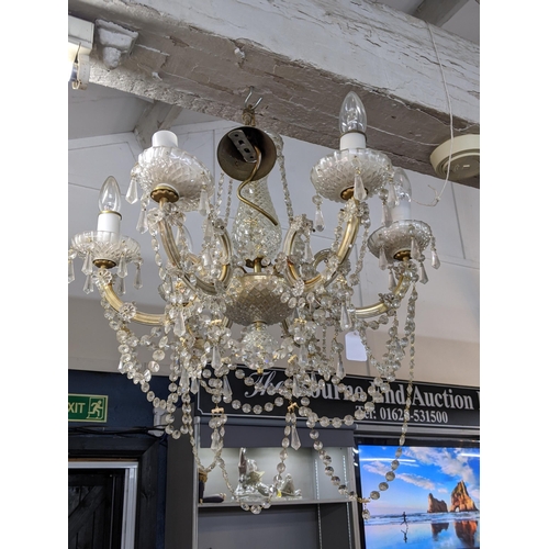 449 - A pair of glass and brass effect six branch chandeliers with fluted pendant drop and swag decoration... 