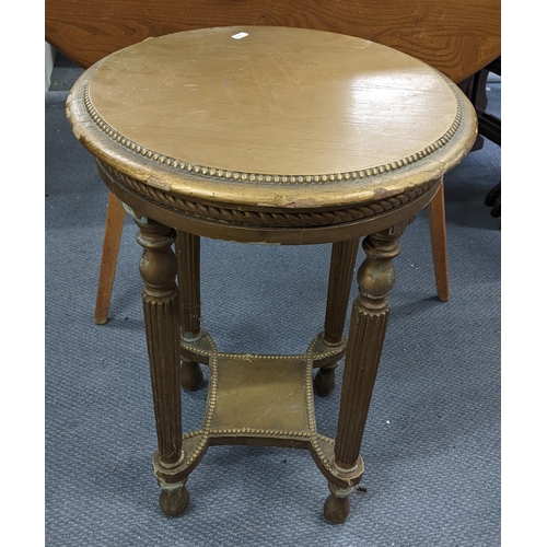 468 - An early/mid 20th century French gilt painted circular topped two tier table having a beaded top and... 