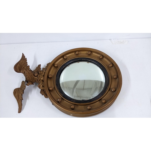 489 - A 19th century carved giltwood mirror with a convex plate surmounted by an eagle, 65cm h A/F
Locatio... 