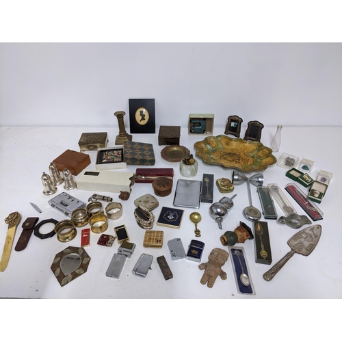 502 - A mixed lot to include two silver photograph frames, a John Sterling lighter and others, celluloid l... 