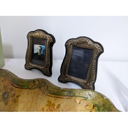 502 - A mixed lot to include two silver photograph frames, a John Sterling lighter and others, celluloid l... 