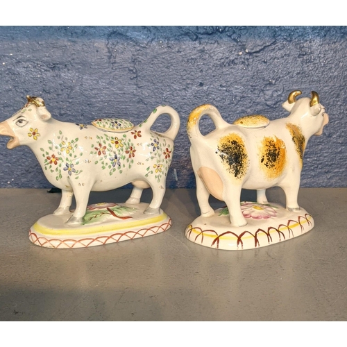 405 - A late 19th/early 20th century Staffordshire cow creamer together with a late 20th century creamer
L... 