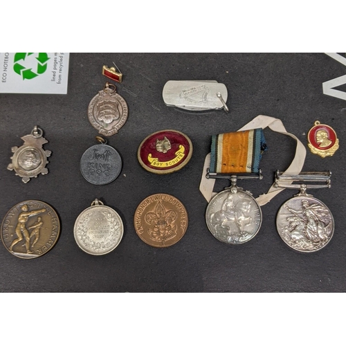 409 - **THIS LOT HAS BEEN WITHDRAWN**
Mixed medals and badges to include an Elizabeth II naval general ser... 